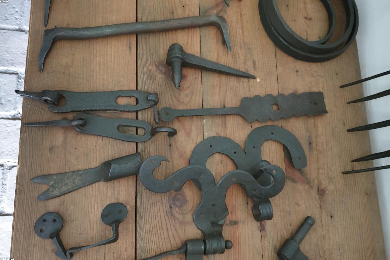 A small set of essential garden tools laid out on a bench.